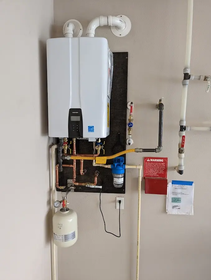 Professional plumber installing copper piping in a Almira home